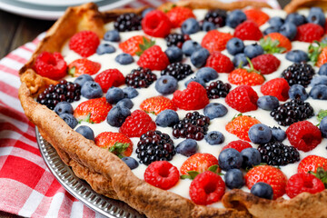 Berries Tart With White Cream On Wooden Background. Close up.