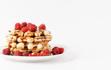 Stack Of Belgium Waffles With Chocolate Syrup And Fresh Raspberries On White Background. Side View. Copy Space.