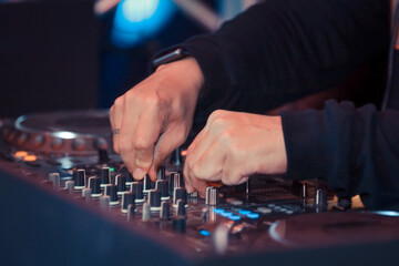 hand playing knobs on turntable