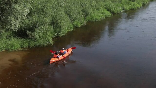 Kayaking on the River. Girls tourists kayaking down the river, teamwork. canoes on the river