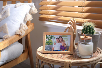 Frame with photo of lovely family on table indoors