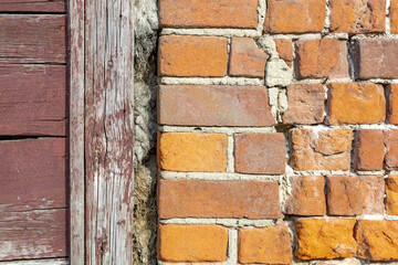 Embossed textured surface of an old wall made of facade bricks and cement
