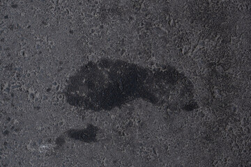 Wet footprints on the asphalt