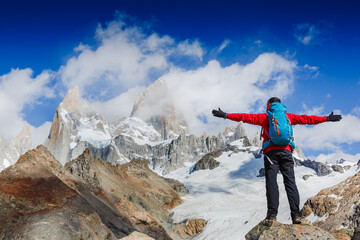 Active hiker hiking, enjoying the view, looking at Patagonia mountain landscape. mountaineering sport lifestyle concept