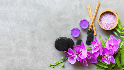 Fototapeta na wymiar Thai Spa Treatments aroma therapy salt and sugar scrub massage with purple orchid flower on backboard with candle
