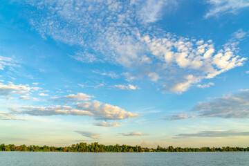 Blue sky and beautiful cloud while sunset with river and tree. Nature landscape for  background, banner or summer poster