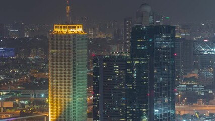 Aerial view of skyscrapers with World Trade center in Dubai night timelapse.