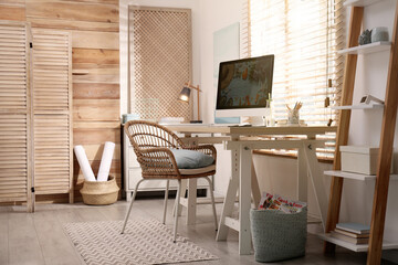 Comfortable workplace with modern computer near window. Interior design