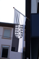 Black and white flag of City of Bregenz on a sunny summer day blowing in the wind. Photo taken August 15th, 2021, Bregenz, Austria.
