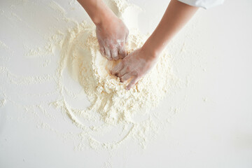 woman baker in chef's clothes professional working with dough kitchen