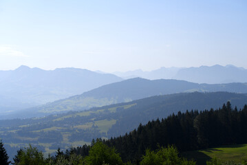 Fototapeta na wymiar Beautiful scenic mountain panorama seen from local mountain Pfänder on a sunny summer day. Photo taken August 15th, 2021, Bregenz, Austria.
