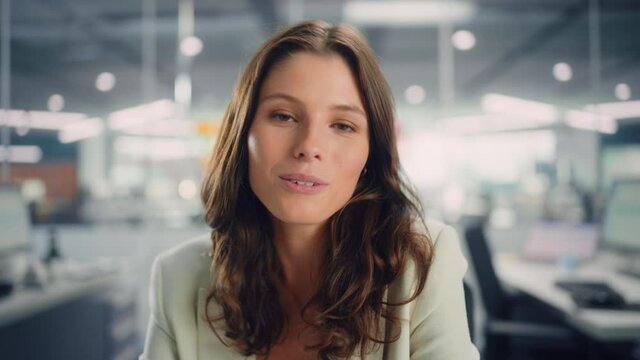 Portrait of a Young Confident Female Manager Talking with Clients on Video Call in Modern Office. Business Conference Call on Computer with Partners, Colleagues, Family or Friends. POV View.