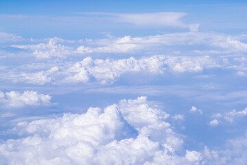 Aerial view of clouds and sky as seen through the window of an aircraft