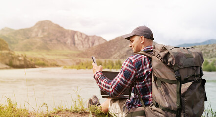 one hiker men using mobile phone in the countryside