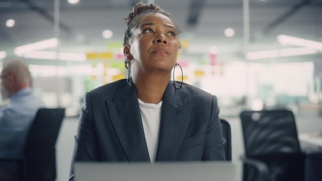 Busy African American Female Manager Using Computer in Modern Office. Overworked Tired Employee Dealing with Hard Work Tasks. Stressed Beautiful Woman Exhausted to Come Up with New Business Ideas.