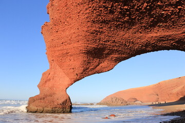 exotic orange giant rock with a hole, legzira, morocco