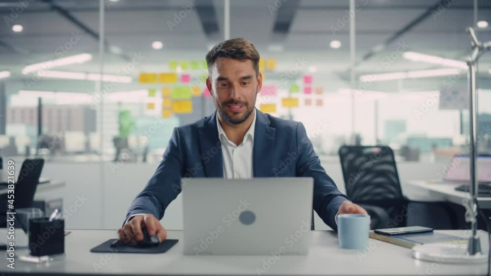 Aufkleber Young Happy Businessman Using Computer in Modern Office with Colleagues. Stylish Handsome Manager Smiling, Working on Financial and Marketing Projects. Drinking Tea or Coffee from a Mug.