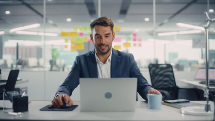 Young Happy Businessman Using Computer in Modern Office with Colleagues. Stylish Handsome Manager Smiling, Working on Financial and Marketing Projects. Drinking Tea or Coffee from a Mug. - Powered by Adobe