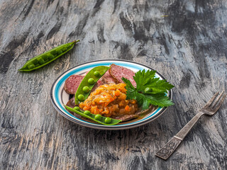 Light breakfast with sausage, vegetable stew and fresh herbs