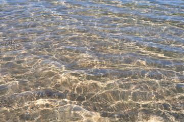 Crystalline sea water over the sand on a beach. Biarritz, France.