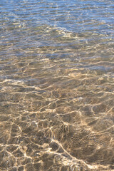 Crystalline sea water over the sand on a beach. Biarritz, France.