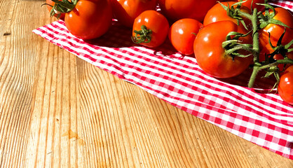 Red tomatoes on wooden background. Fresh vegetables top view with copy space for text. Flat lay. The concept of the harvest, vegetable garden. Natural products, agriculture. Lay out