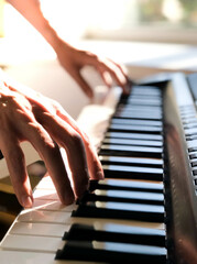 Obraz premium Pianist hand playing digital piano. Close-up. Music concept, learning to play the piano. Space for text. Vectical