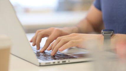 Plakat Close up of Male Hands Typing on Laptop 