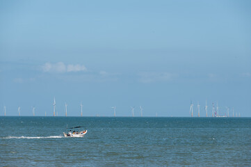 On a sunny day in summer, the speedboat drove fast in the blue sea