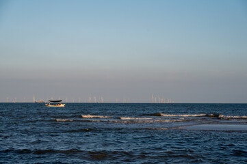 On a sunny day in summer, the speedboat drove fast in the blue sea