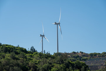 Under the blue sky, there was a windmill on the mountain