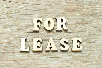 Alphabet letter in word for lease on wood background