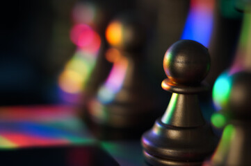 Closeup shot of colorful bokeh lights on chess pieces