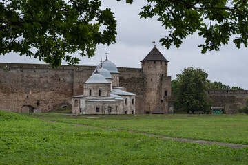 Fototapeta na wymiar Ancient Church of Saint Nicholas and Church of Dormition of the Mother of God on territory of Ivangorod Fortress that was built in 1492. Ivangorod, Russia