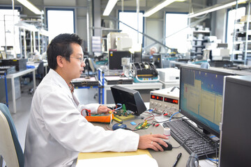 engineer at the workplace - assembly and development of electronics in a modern factory