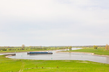 Dutch cargo inland ship on the river IJssel near Zutphen in Gelderland