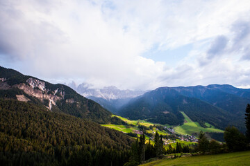 Fototapeta na wymiar Sunset and rainbow in Val Di Funes, Dolomites, Alps, Italy