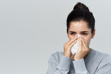 woman wiping her nose with a handkerchief flu health problems treatment