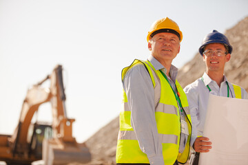 Business people and workers standing in quarry