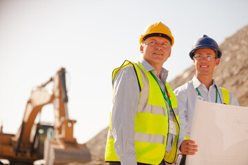 Business people and workers standing in quarry