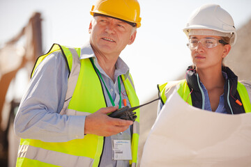 Worker holding clipboard on site