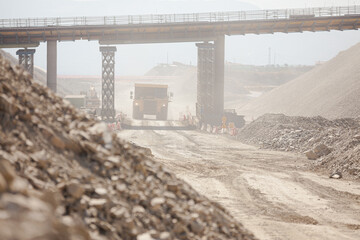 Business people reading blueprints in quarry