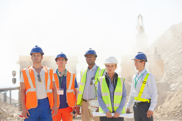 Business people and workers talking in quarry