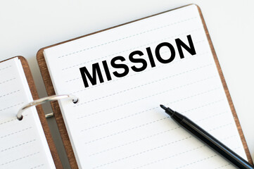 notepad with word Mission on white background near black marker