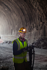 Businessman and worker standing in tunnel