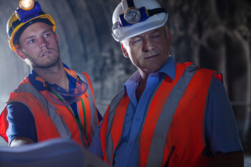 Worker using laptop in tunnel