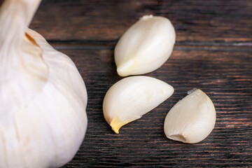 Garlic cloves and head close-up on a wooden background