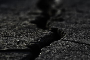 asphalt in cracks texture / abstract background cracks on asphalt road