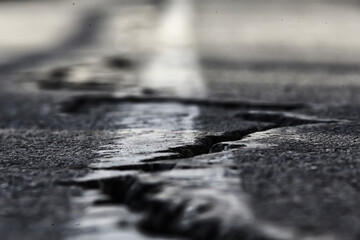 asphalt in cracks texture / abstract background cracks on asphalt road