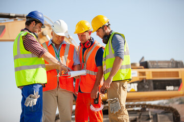 Worker standing on machinery on site